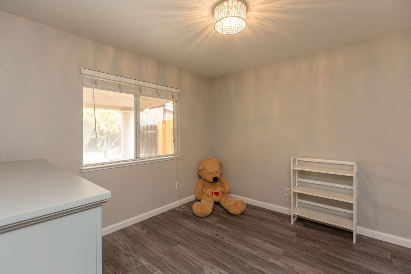 2085 Roth Court Turlock, CA 95380 - Photo 20 of 26 a view of room with window and wooden floor