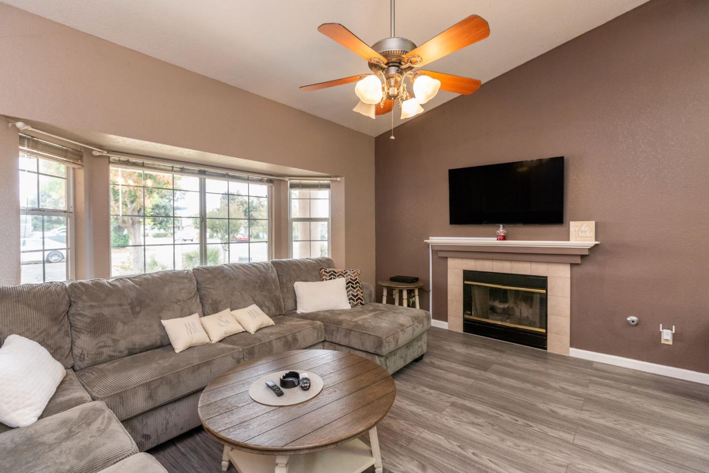 2085 Roth Court Turlock, CA 95380 - Photo 5 of 26 a living room with furniture a fireplace and a flat screen tv