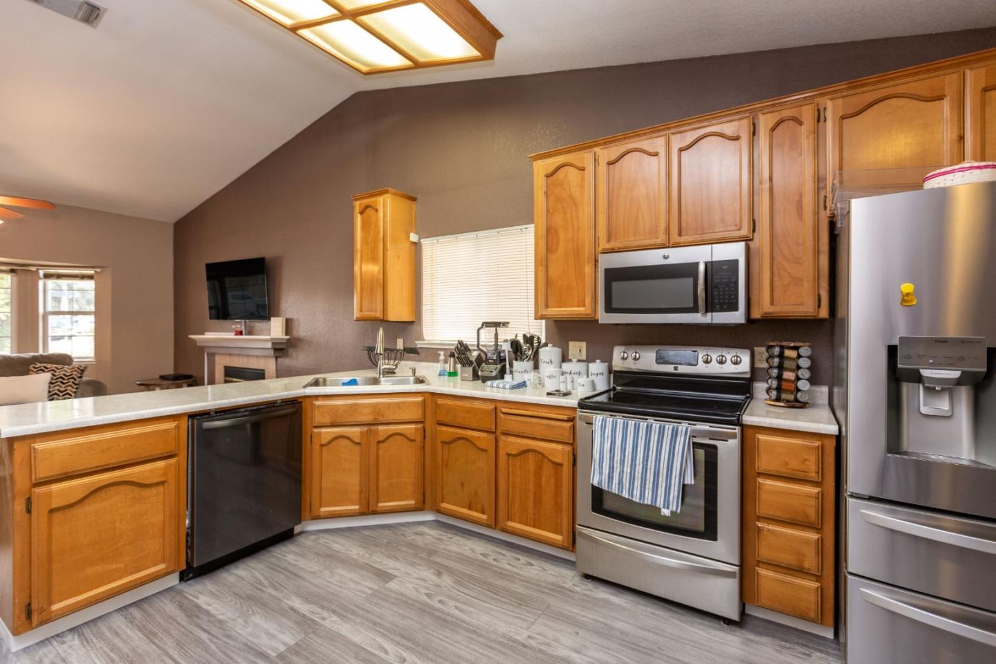 2085 Roth Court Turlock, CA 95380 - Photo 10 of 26 a kitchen with stainless steel appliances granite countertop wooden cabinets a stove top oven a sink and dishwasher