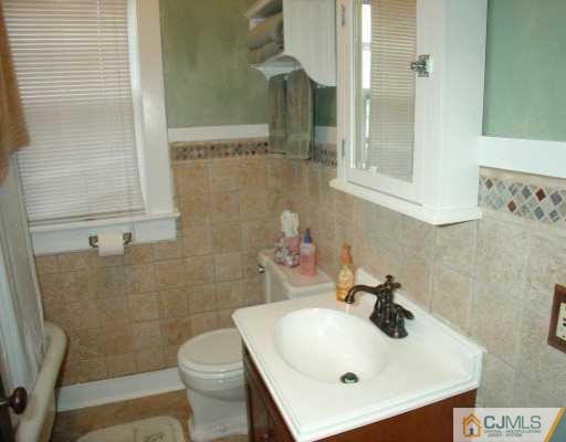 631 Ridge Road Monmouth Junction, NJ 08852 - Photo 8 of 8 a bathroom with a sink a toilet and shower