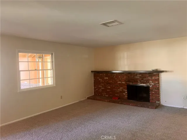 an empty room with furniture and fireplace