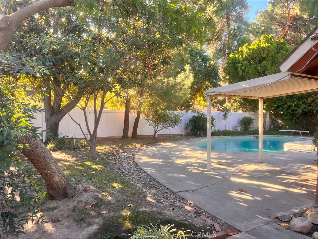 3694 Gay Way Riverside, CA 92504 - Photo 9 of 26 a view of a yard with a table and chairs under an umbrella
