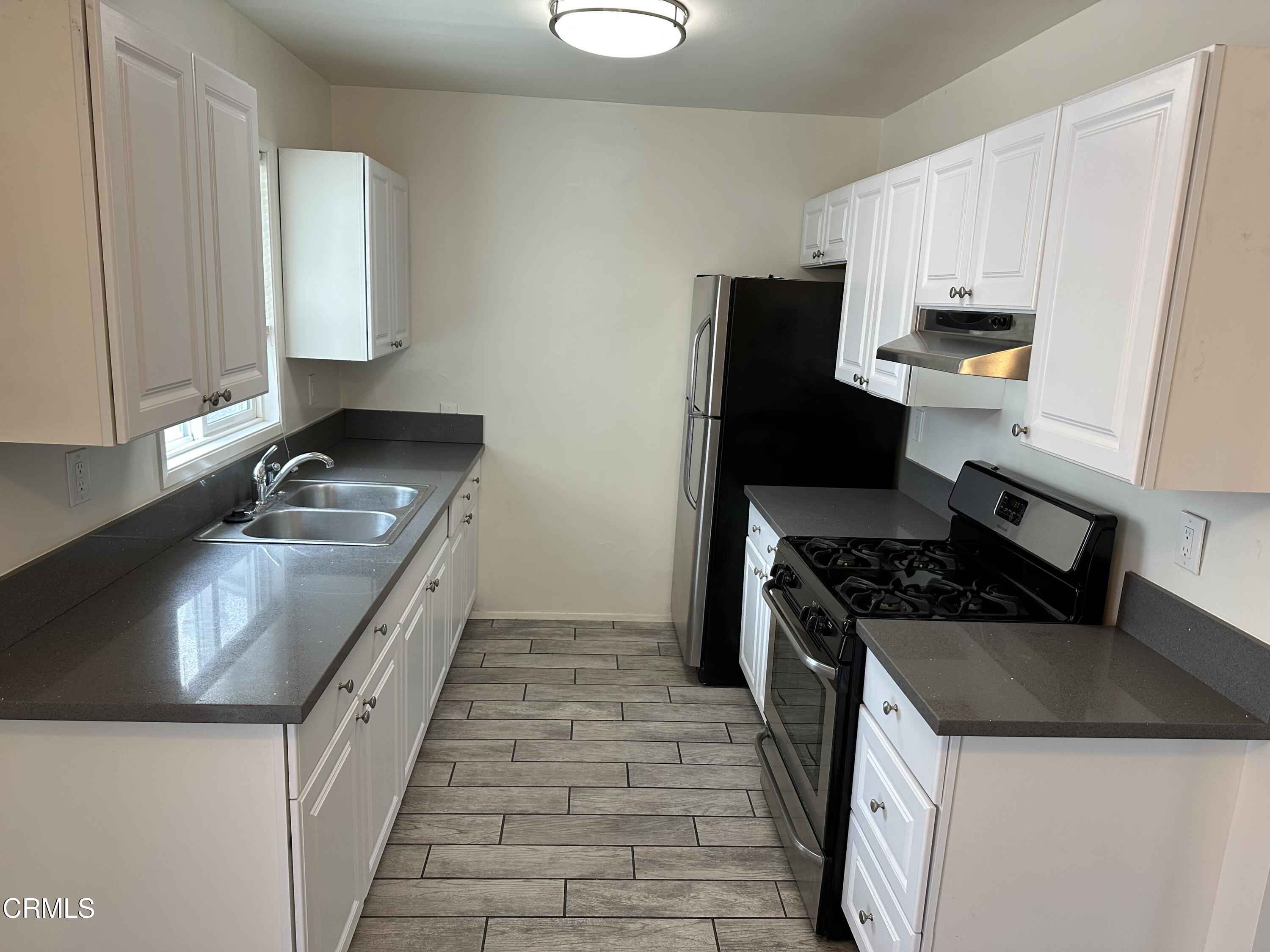 1148 Spazier Avenue, Unit B Glendale, CA 91201 - Photo 12 of 31 a kitchen with granite countertop a sink stove and refrigerator