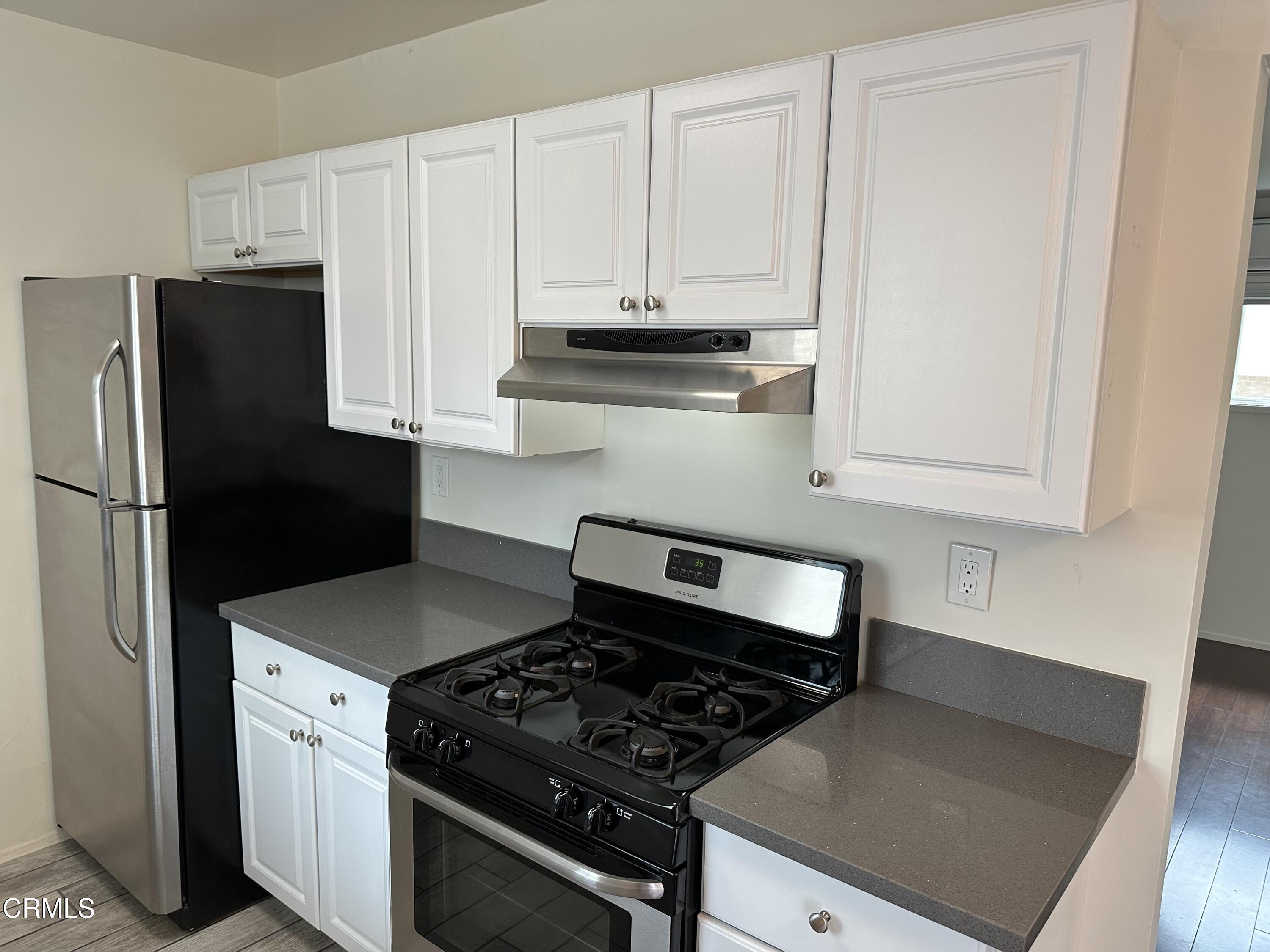 1148 Spazier Avenue, Unit B Glendale, CA 91201 - Photo 16 of 31 a kitchen with white cabinets and appliances