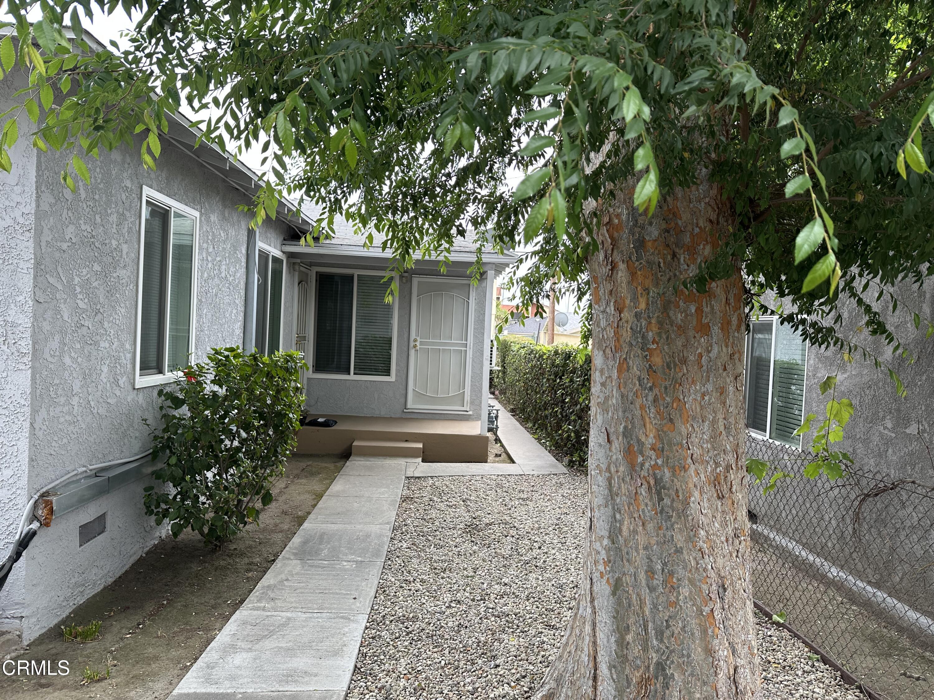1148 Spazier Avenue, Unit B Glendale, CA 91201 - Photo 2 of 31 a house with trees in front of it