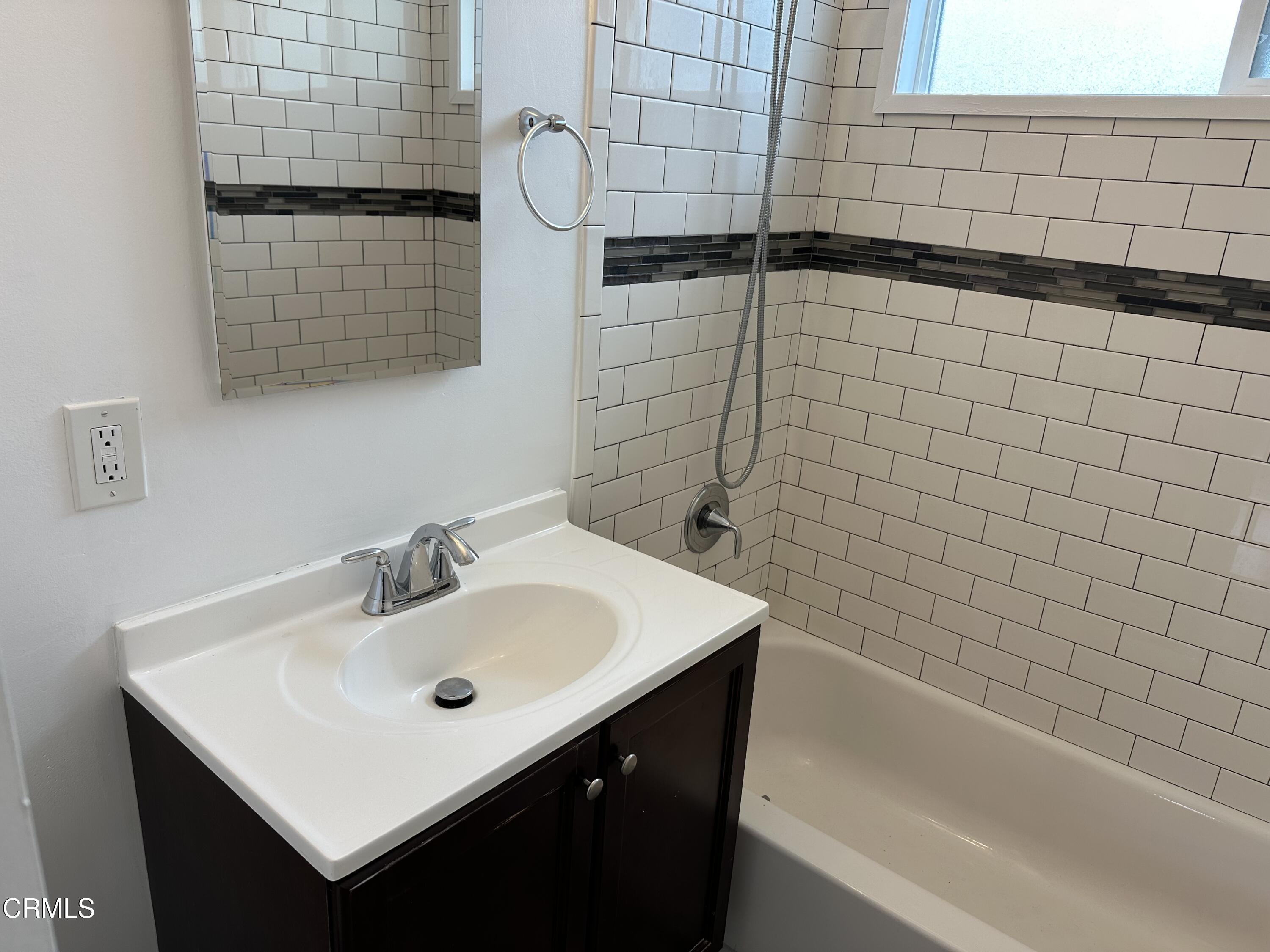 1148 Spazier Avenue, Unit B Glendale, CA 91201 - Photo 24 of 31 a bathroom with a sink vanity and tub
