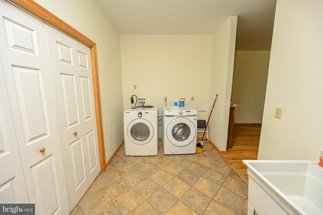 a large bed sitting in a bedroom next to a window