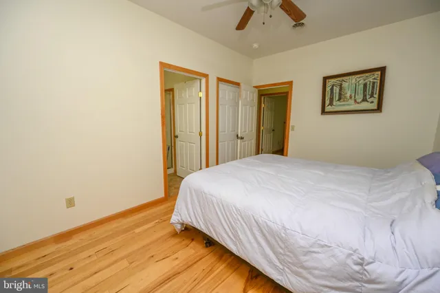 a bedroom with a bed and wooden floor