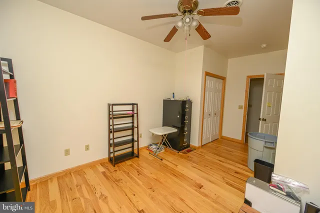 a spacious bedroom with a bed and a walk in closet