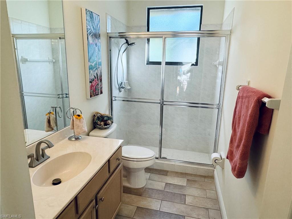 10919 Parnu Street Naples, FL 34109 - Photo 12 of 35 a bathroom with a sink toilet and shower