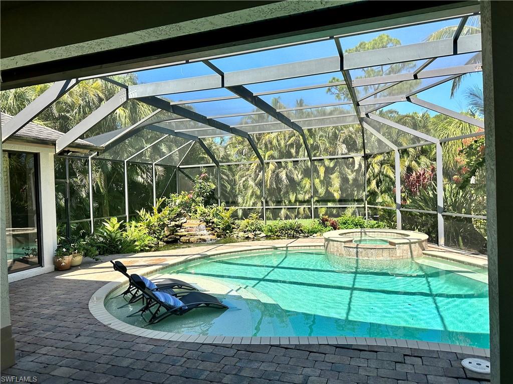 10919 Parnu Street Naples, FL 34109 - Photo 24 of 35 a view of a swimming pool with a yard and plants