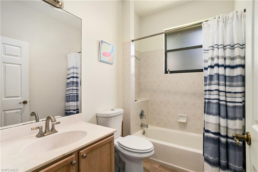 10919 Parnu Street Naples, FL 34109 - Photo 10 of 35 a bathroom with a sink toilet and shower