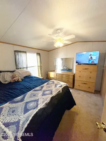 a bedroom with a bed and a dresser