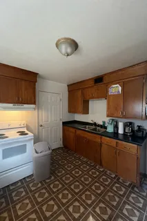 a kitchen with a sink and wooden cabinets