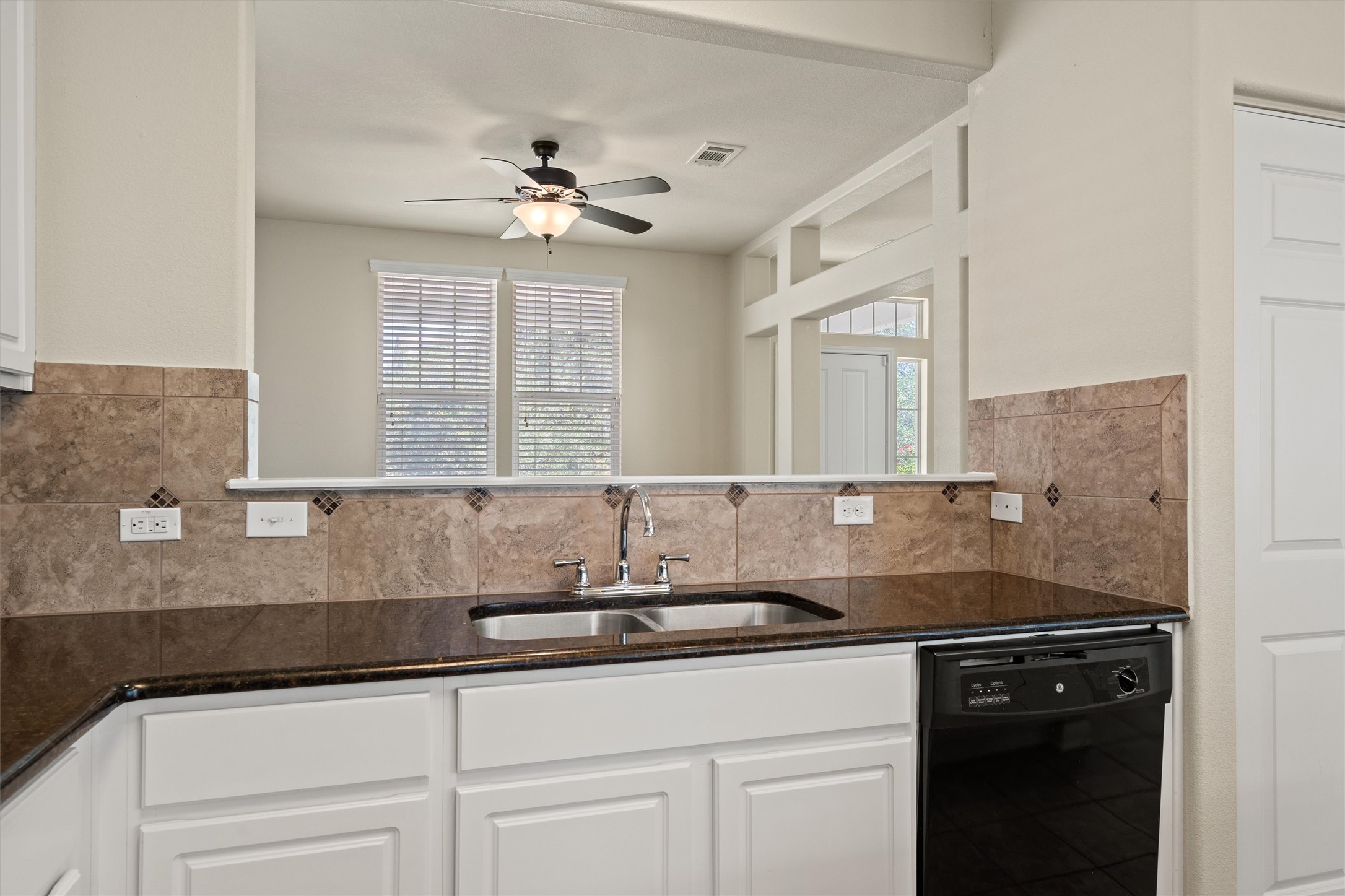 423 Wetzel Kyle, TX 78640 - Photo 17 of 35 Kitchen featuring dark stone countertops, dishwasher, white cabinetry, and ceiling fan