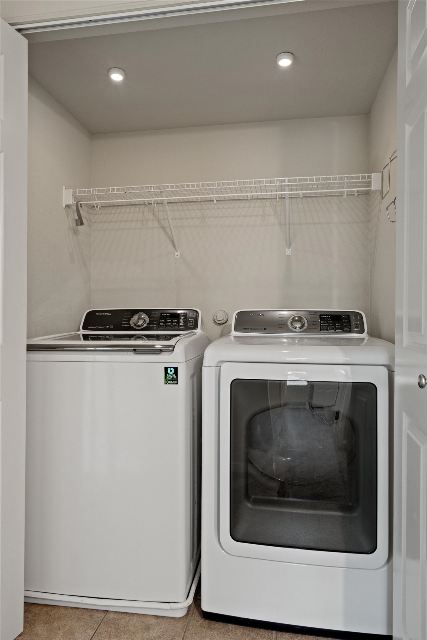 423 Wetzel Kyle, TX 78640 - Photo 29 of 35 Laundry area with independent washer and dryer, light tile patterned flooring, and recessed lighting