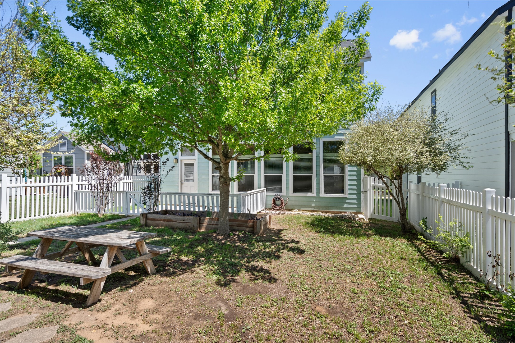423 Wetzel Kyle, TX 78640 - Photo 32 of 35 Rear view of property with a fenced backyard and a wooden deck