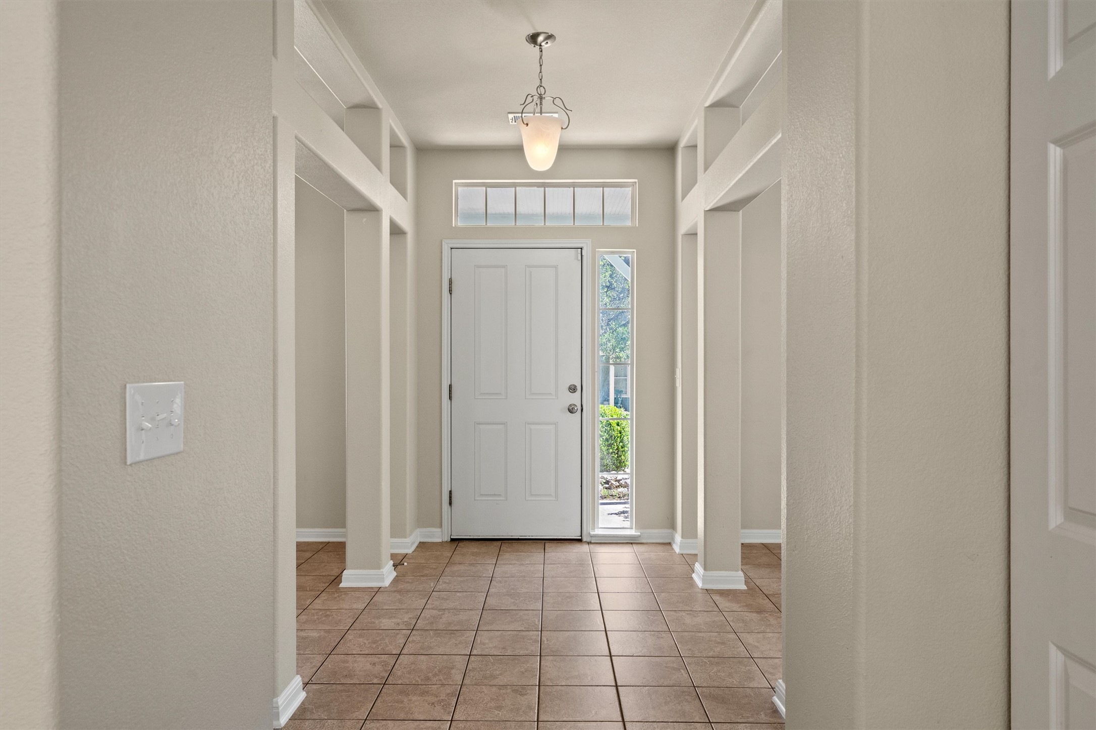 423 Wetzel Kyle, TX 78640 - Photo 7 of 35 Foyer entrance featuring a textured wall and light tile patterned floors