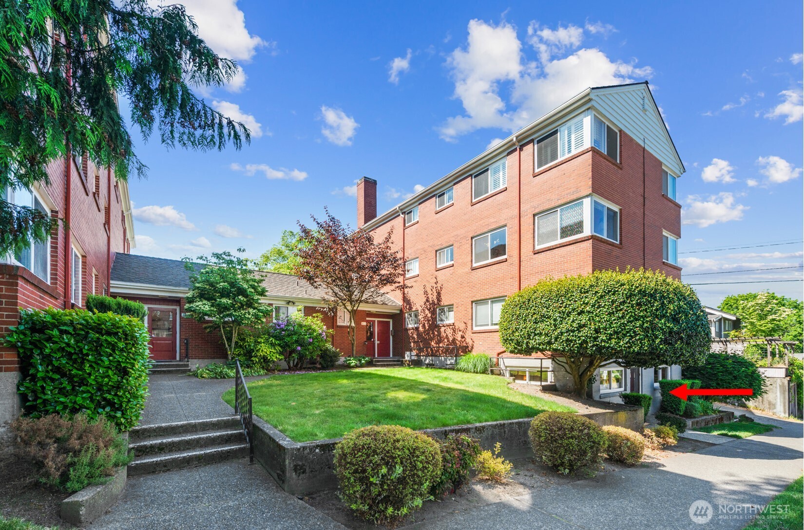 4407 Southwest Alaska Street, Unit 11 Seattle, WA 98116 - Photo 2 of 24 a view of a house with a yard and garden