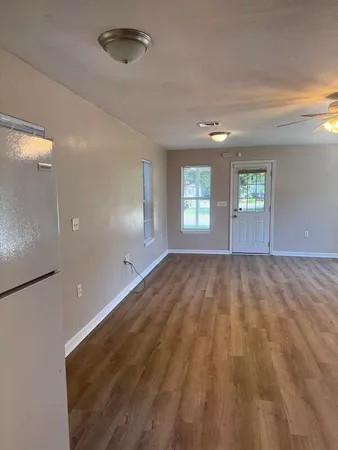 wooden floor in an empty room with windows