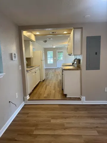 a view of a kitchen with wooden floor