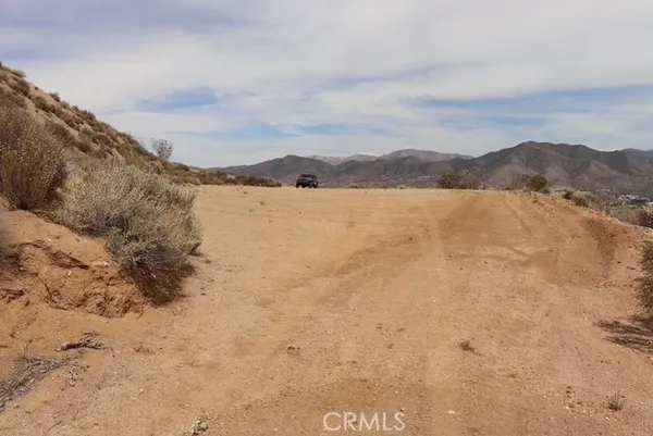a view of a town with mountains in the background