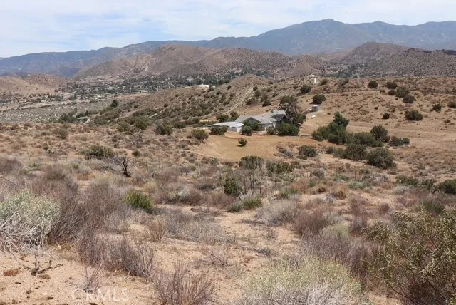a view of a lush green hillside and houses