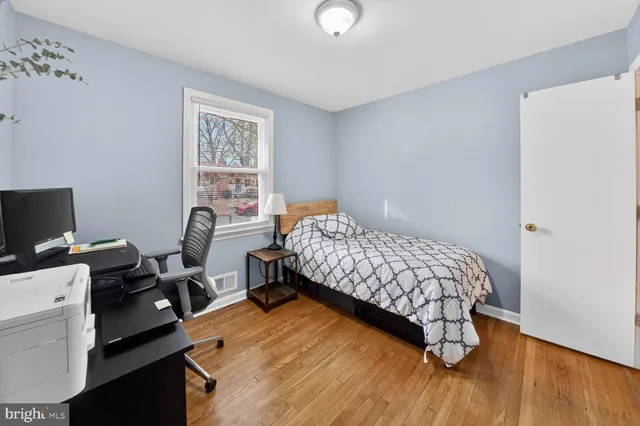 a bedroom with a bed and a tv on the table