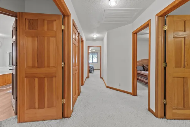 a view of a hallway with wooden floor and entryway