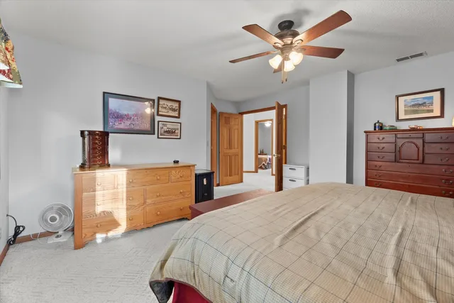 a bedroom with a bed and a dresser