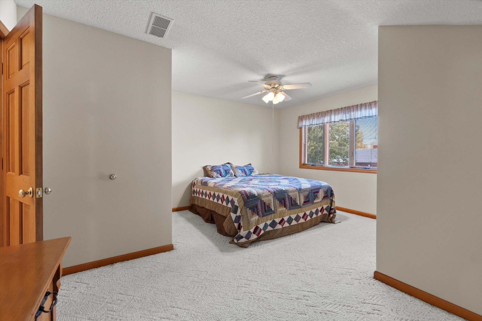 15344 Norrish Road Morrison, IL 61270 - Photo 25 of 50 a spacious bedroom with a bed and a chandelier
