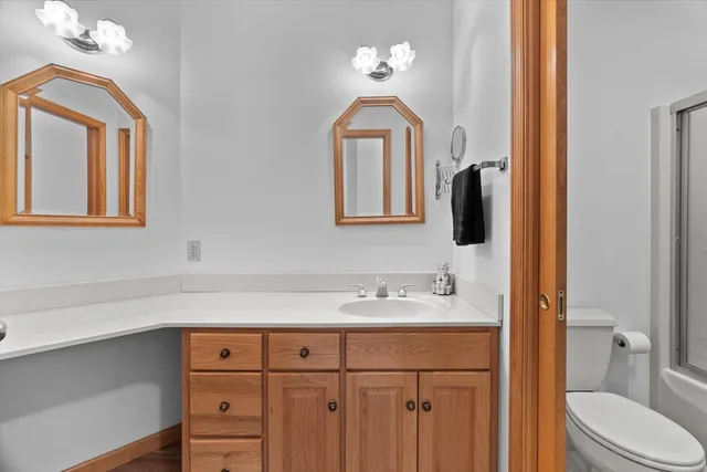 a bathroom with a sink a toilet and mirror