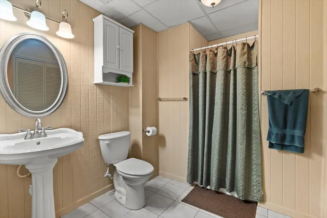 a bathroom with a sink a mirror and toilet