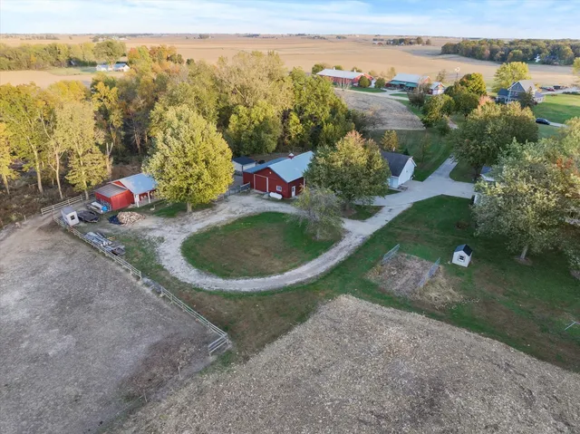 an aerial view of residential houses with outdoor space and trees