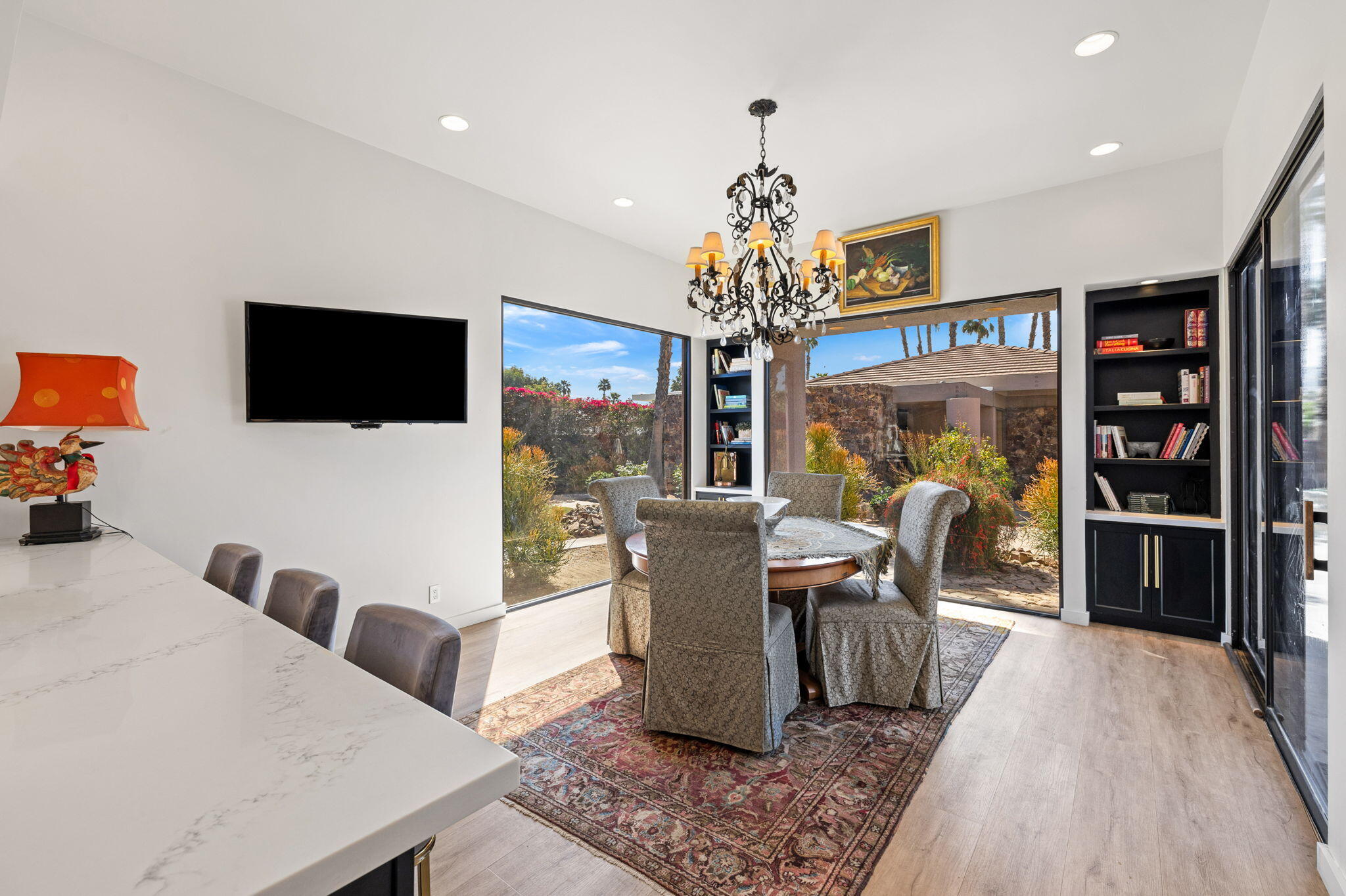 7 Big Sioux Road Rancho Mirage, CA 92270 - Photo 20 of 64 a living room with furniture a chandelier and a flat screen tv