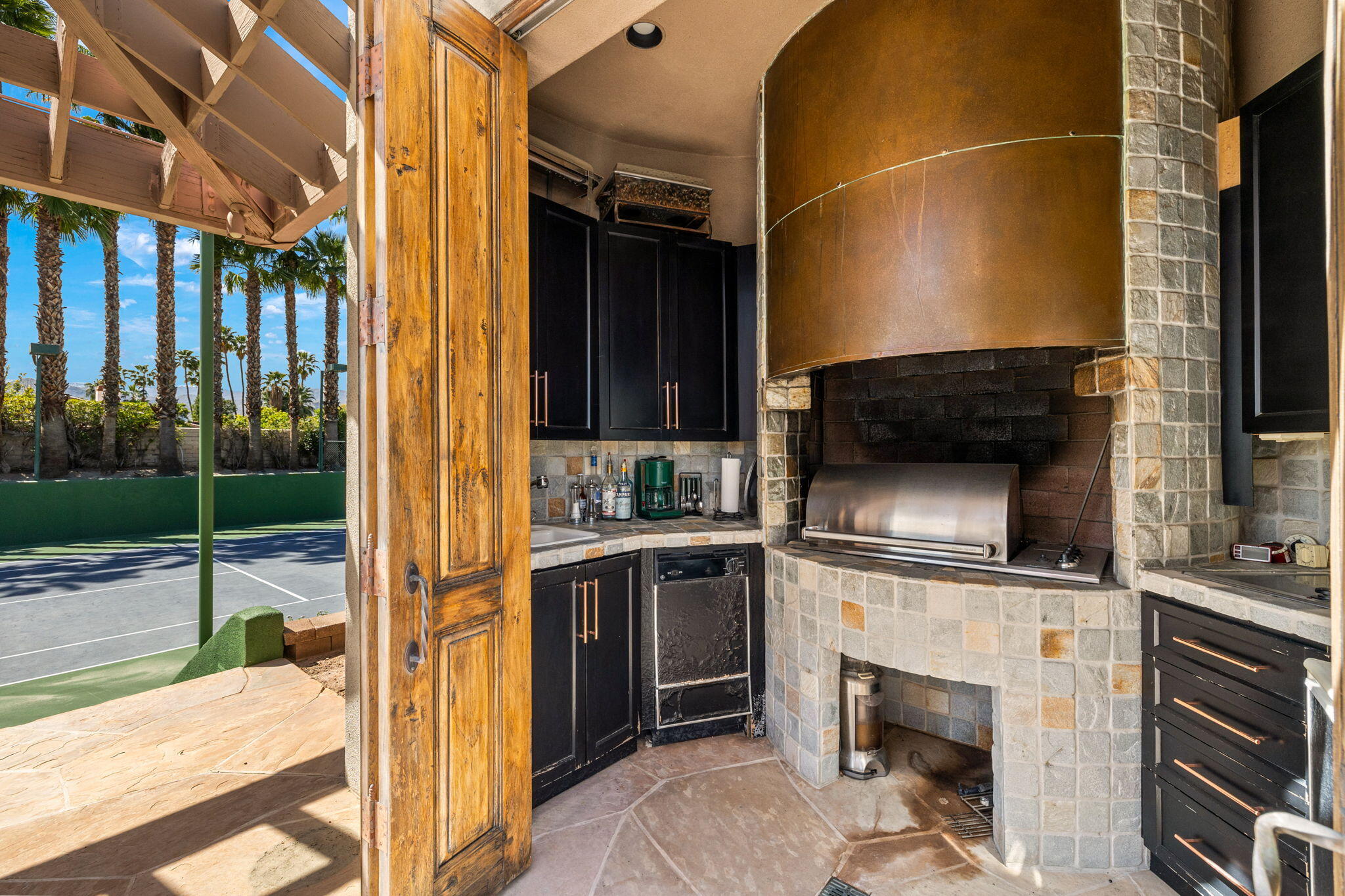 7 Big Sioux Road Rancho Mirage, CA 92270 - Photo 52 of 64 a kitchen view with a sink stainless steel appliances wooden floor and cabinets