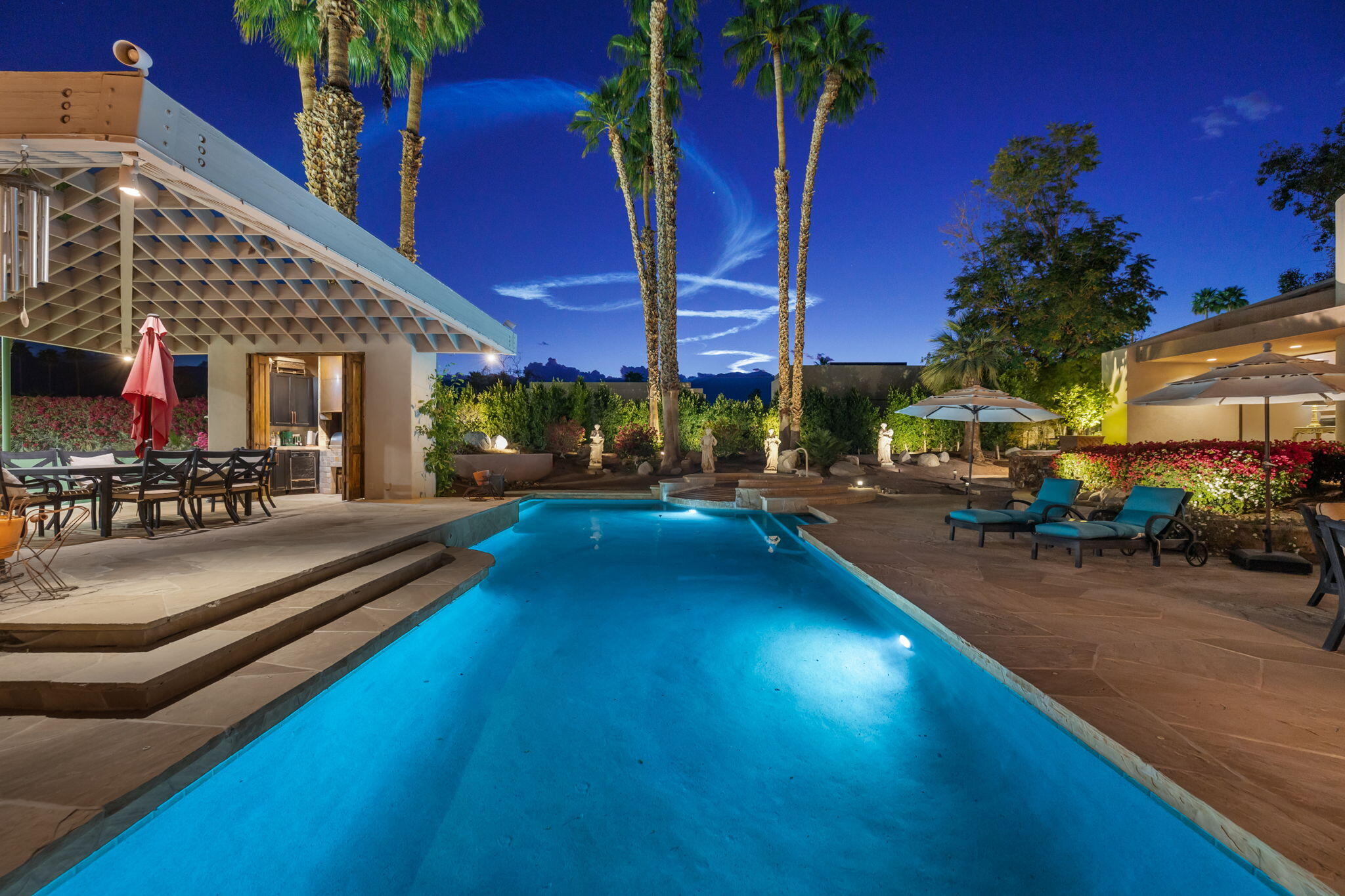 7 Big Sioux Road Rancho Mirage, CA 92270 - Photo 54 of 64 a view of a swimming pool with a bench in front of building