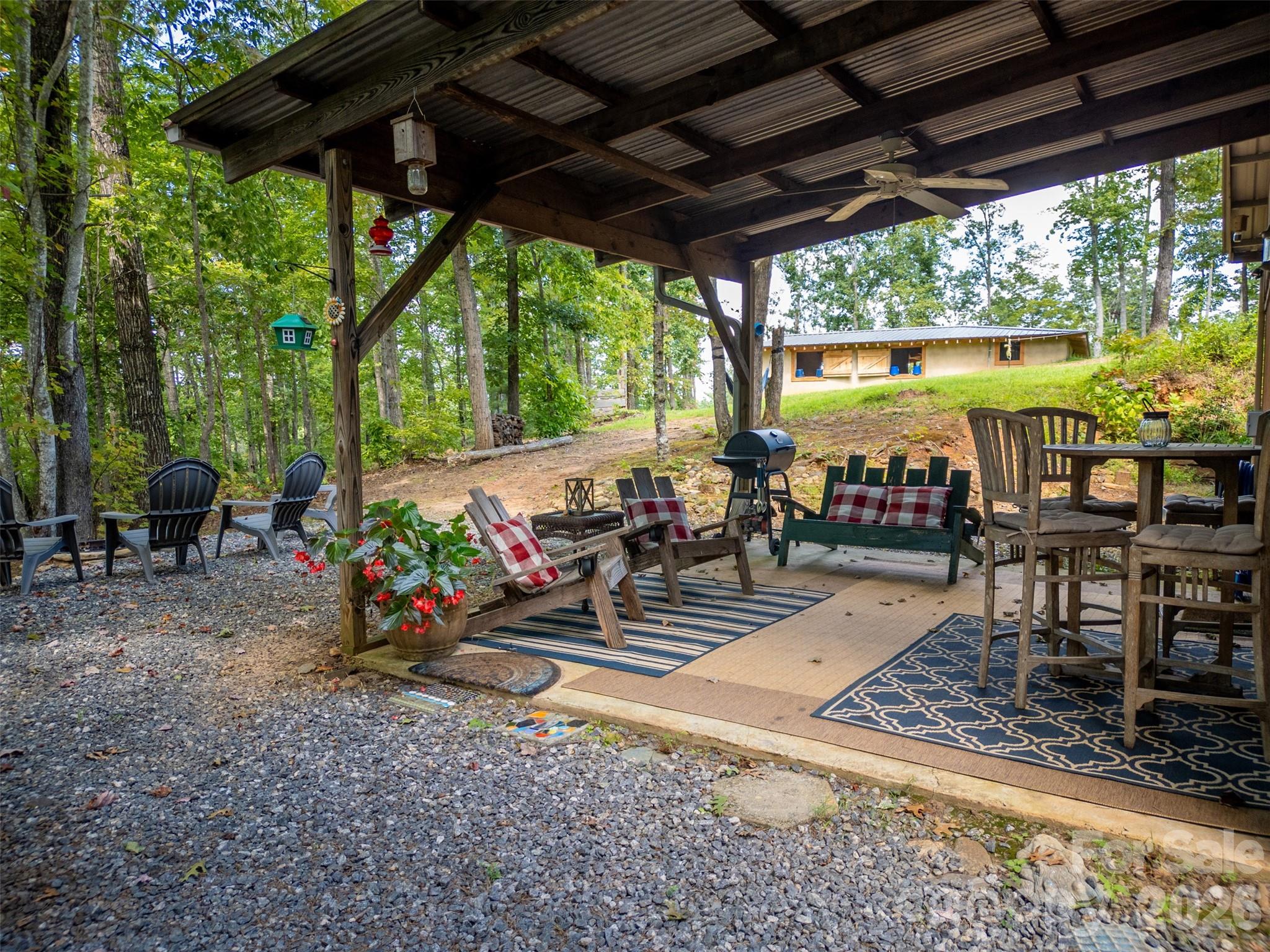 250 Burt Blackwell Road Mill Spring, NC 28756 - Photo 36 of 47 a view of a chairs and table in patio