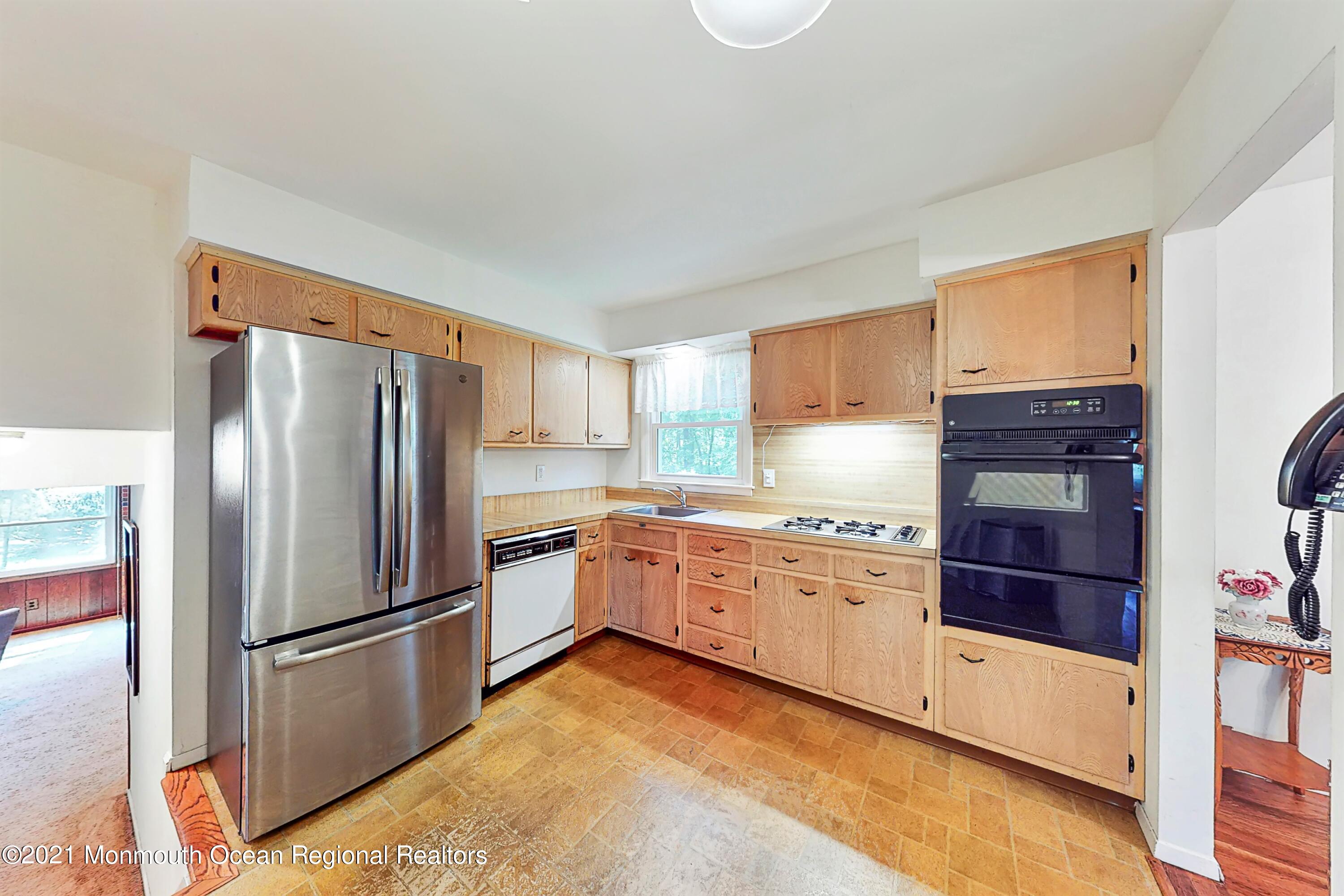 10 High Point Road Lincroft, NJ 07738 - Photo 14 of 53 a kitchen with granite countertop stainless steel appliances a refrigerator a stove top oven and cabinets