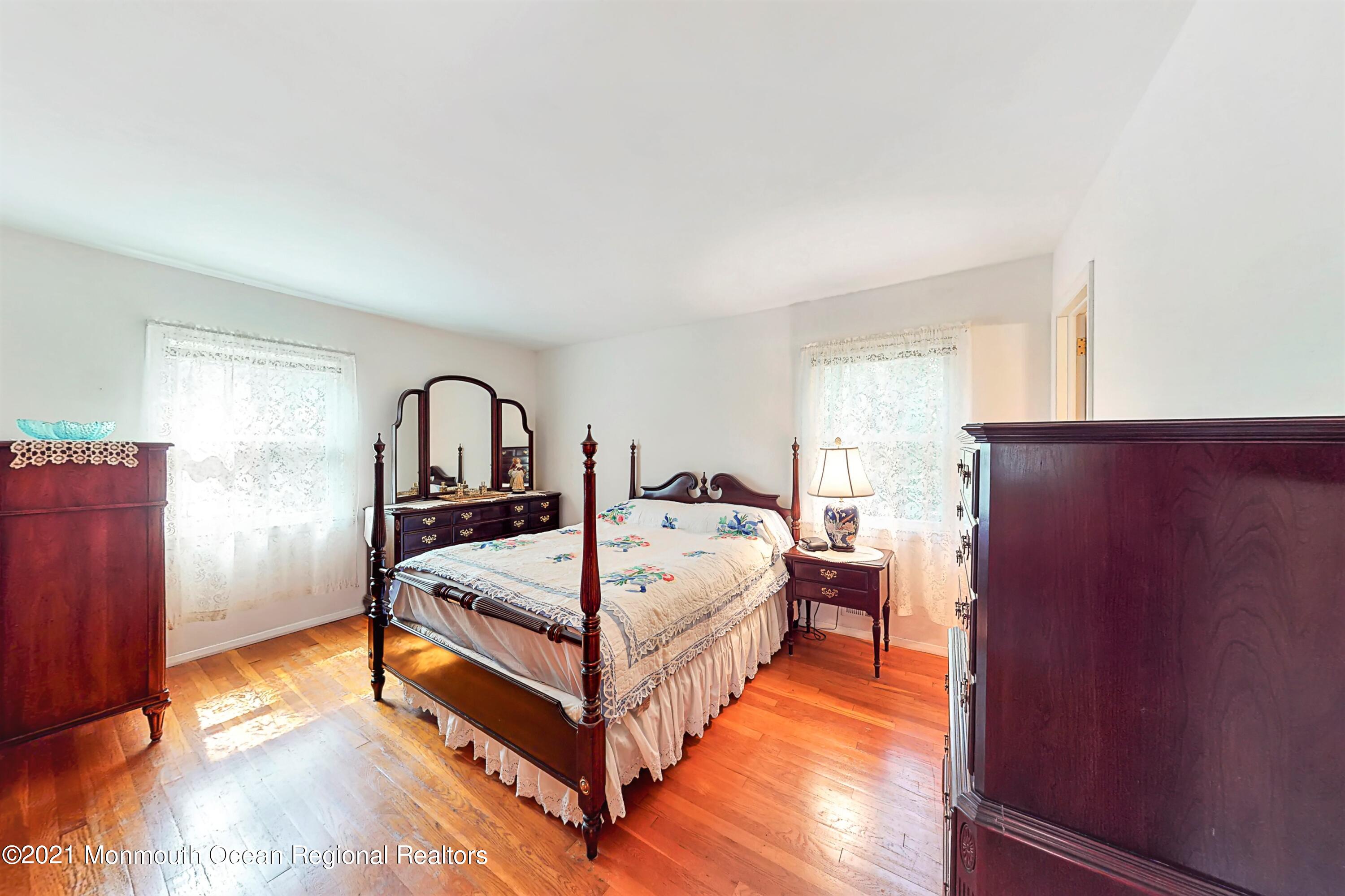10 High Point Road Lincroft, NJ 07738 - Photo 22 of 53 a bed sitting in a bedroom next to a window with lamp