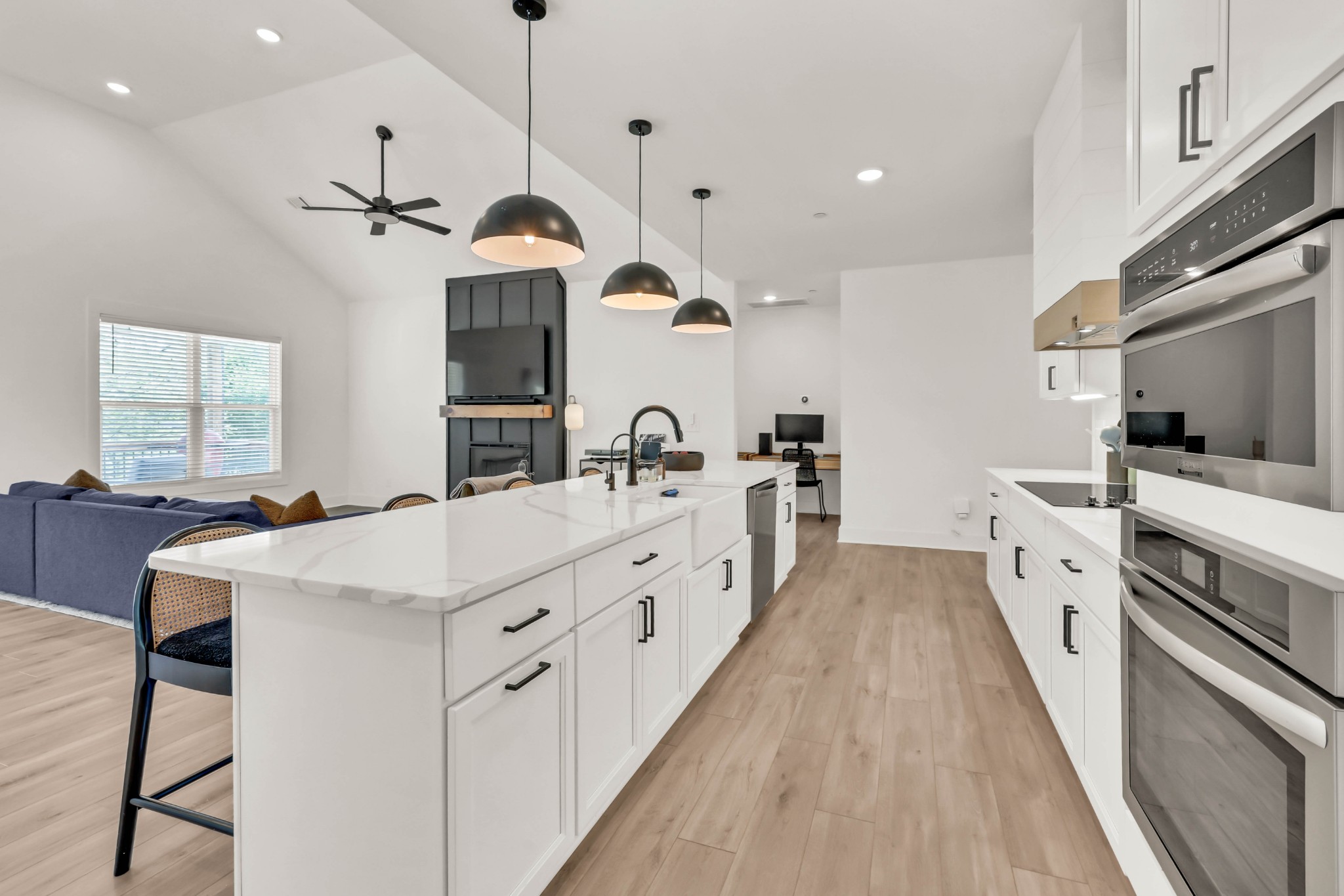623 Centre Street Pleasant View, TN 37146 - Photo 15 of 53 a large white kitchen with a stove a sink a refrigerator and a dining table with wooden floor