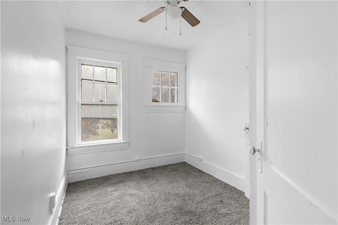 324 Root Road Lorain, OH 44052 - Photo 11 of 38 Carpeted empty room featuring a textured ceiling and ceiling fan