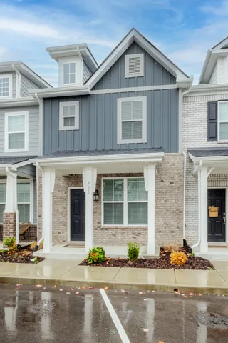 a front view of a house with a garden and plants