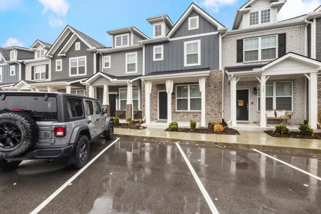 a view of a white house with a large windows and couches