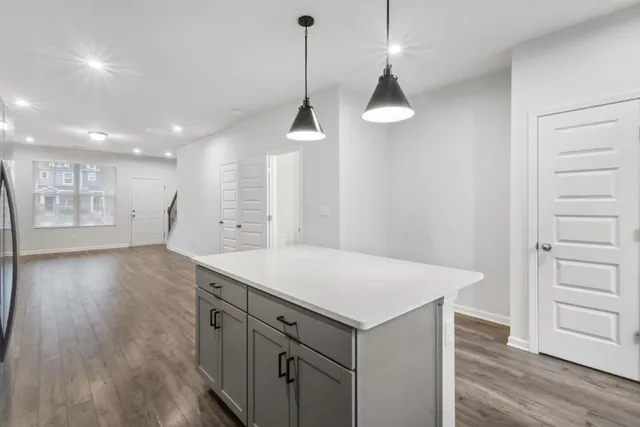 a kitchen with a wooden floor and window