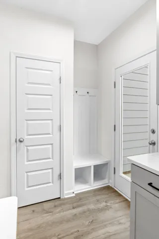 a view of an empty room with wooden floor