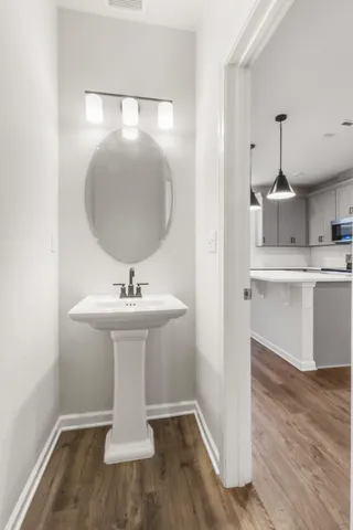 a bathroom with a sink a mirror and vanity