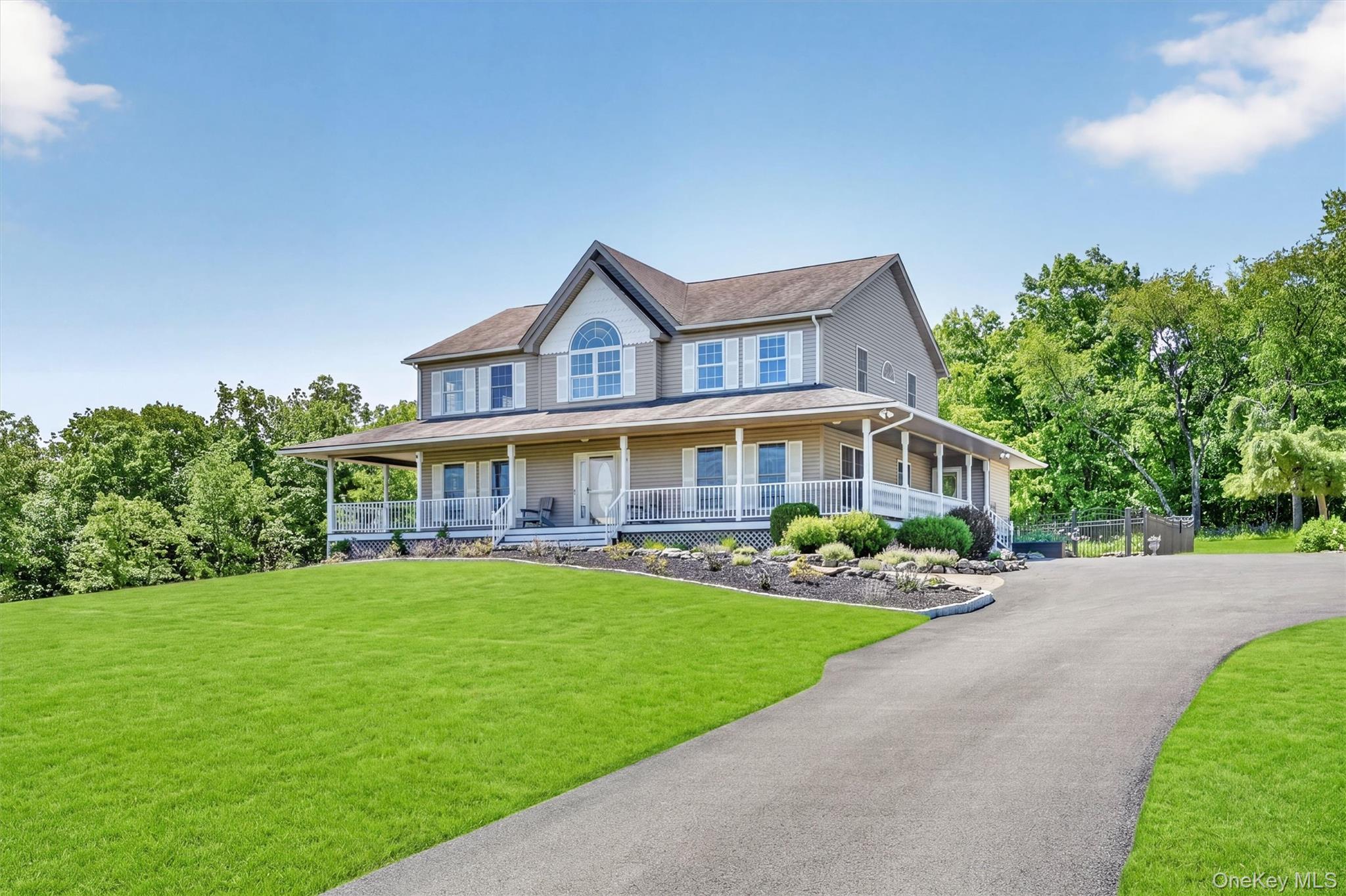 954 Ridgebury Road New Hampton, NY 10958 - Photo 44 of 45 The home sits beautifully against the landscape, with its wraparound porch, manicured grounds, and classic exterior offering timeless curb appeal.