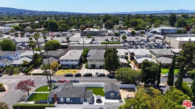 an aerial view of a house with a yard and potted plants