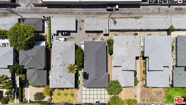 an aerial view of a house with a yard